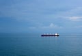 Bulk cargo ship with cranes, sailing through calm, blue ocean. Royalty Free Stock Photo