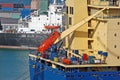Bulk cargo ship in harbor with pinnace Royalty Free Stock Photo