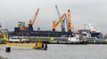 Bulk Carrier Cargo Ship with Deck Cranes Under Loading in Port Royalty Free Stock Photo