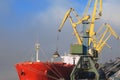 Mountains of coal on the territory of the Murmansk Commercial Sea Port. The unloading of wagons with coal and the loading of this Royalty Free Stock Photo