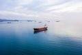 Bulk carrier ship at anchor in orange sunset, aerial view. Colored sky Royalty Free Stock Photo