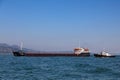 Bulk-carrier ship and tugboat Royalty Free Stock Photo