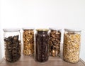 Bulk foods storage in glass jars: dry wild mushrooms, muesli, chocolate and nuts