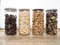 Bulk foods storage in glass jars: dry wild mushrooms, muesli and nuts