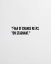 Soft White Background with Fear of Change Keeps You Stagnant Quote for Positive Vibe Wall Decor Royalty Free Stock Photo