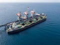 Bulk container ship unloads coal in the port of power station.