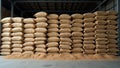 Bulk storage warehouse with stacks of grain filled burlap sacks Royalty Free Stock Photo