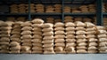 Bulk storage warehouse with stacks of grain filled burlap sacks Royalty Free Stock Photo