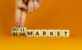Bull or bear market symbol. Businessman turns wooden cubes and changes words Bear market to Bull market. Beautiful orange table Royalty Free Stock Photo