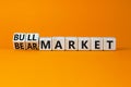Bull or bear market symbol. Turned wooden cubes and changed concept words Bear market to Bull market. Beautiful orange table Royalty Free Stock Photo