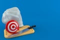 Bull`s eye with kitchen board and chef`s hat Royalty Free Stock Photo