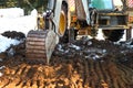 Bulldozer bucket close-up digs a pit for the construction. The foundation of the house, earthworks. The excavator shovels out the