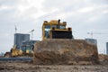 Bulldozer with bucket for pool excavation and utility trenching. Dozers during land clearing and foundation digging. Earth-moving