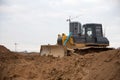 Bulldozer with bucket for pool excavation and utility trenching. Dozers during land clearing and foundation digging. Earth-moving