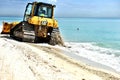 Bulldozer cleaning beach after storm florida usa