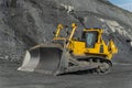 A bulldozer cleans a gold mine site in an open pit. Royalty Free Stock Photo