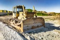 Bulldozer during the construction of a new road. Top view of a powerful working bulldozer. Earthmoving equipment for road works, Royalty Free Stock Photo