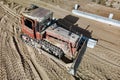 Bulldozer during the construction of a new road. Top view of a powerful working bulldozer. Earthmoving equipment for road works, Royalty Free Stock Photo