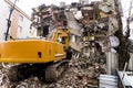 Bulldozer demolishes old buildings. demolition of a building in the harbor area