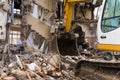 Bulldozer demolishes old buildings. demolition of a building in the harbor area