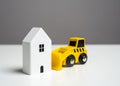 Bulldozer demolishing the house - concept. Illegal buildings construction. Lawsuit. Illegal construction or demolition of a Royalty Free Stock Photo