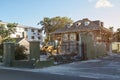 Bulldozer demolishing house