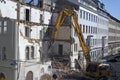 A bulldozer is demolishing an old building construction site in Vienna