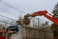 A bulldozer destroys of the demolition of a building under construction of a new house Royalty Free Stock Photo