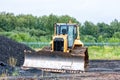 Bulldozer dredges rubble on road construction Royalty Free Stock Photo