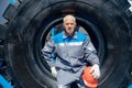 Bulldozer driver coal mine in uniform with helmet and headphones looking to side. Concept man industrial portrait