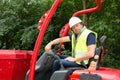 a bulldozer driver with helmet and his safety vest