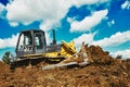 Bulldozer earthmover working with clay or soil