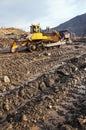 Bulldozer, earthworks in highlands, landscape, autumn.