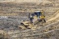 Bulldozer in excavation pit leveling the ground Royalty Free Stock Photo