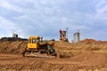 Bulldozer and excavator for earthworks  at construction site. Earth-moving equipment for land clearing, grading and utility Royalty Free Stock Photo