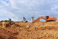 Bulldozer and excavator for earthworks  at construction site. Earth-moving equipment for land clearing, grading and utility Royalty Free Stock Photo