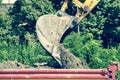 Bulldozer excavator machinery loading ground to dumper truck on the street reconstruction site. Royalty Free Stock Photo