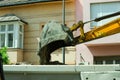 Bulldozer excavator machinery loading ground to tipper truck on the street reconstruction site Royalty Free Stock Photo