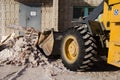 Bulldozer excavator shoveling debris into pile with his ladle