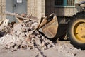 Bulldozer excavator shoveling debris into pile with his ladle