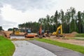 Bulldozer, Excavator and Soil compactor on road work. Earth-moving heavy equipment and Construction machinery  during land Royalty Free Stock Photo