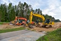 Bulldozer, Excavator and Soil compactor on road work. Earth-moving heavy equipment and Construction machinery  during land Royalty Free Stock Photo