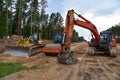 Bulldozer, Excavator and Soil compactor on road work. Earth-moving heavy equipment and Construction machinery  during land Royalty Free Stock Photo