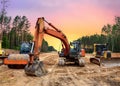 Bulldozer, Excavator and Soil compactor on road work. Earth-moving heavy equipment and Construction machinery during land clearing