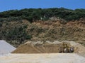 Bulldozer and heaps of sand