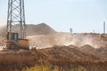 Bulldozer heavy machinery transport raking clay.