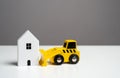 The bulldozer intends to demolish the house. Royalty Free Stock Photo