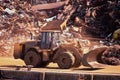 Bulldozer at a landfill with scrap metal