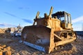 Bulldozer at landfill for work concrete demolition waste. Salvaging and recycling construction materials. Dozer destroys concrete