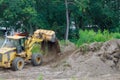 Bulldozer landscaping works on construction working with earth while doing